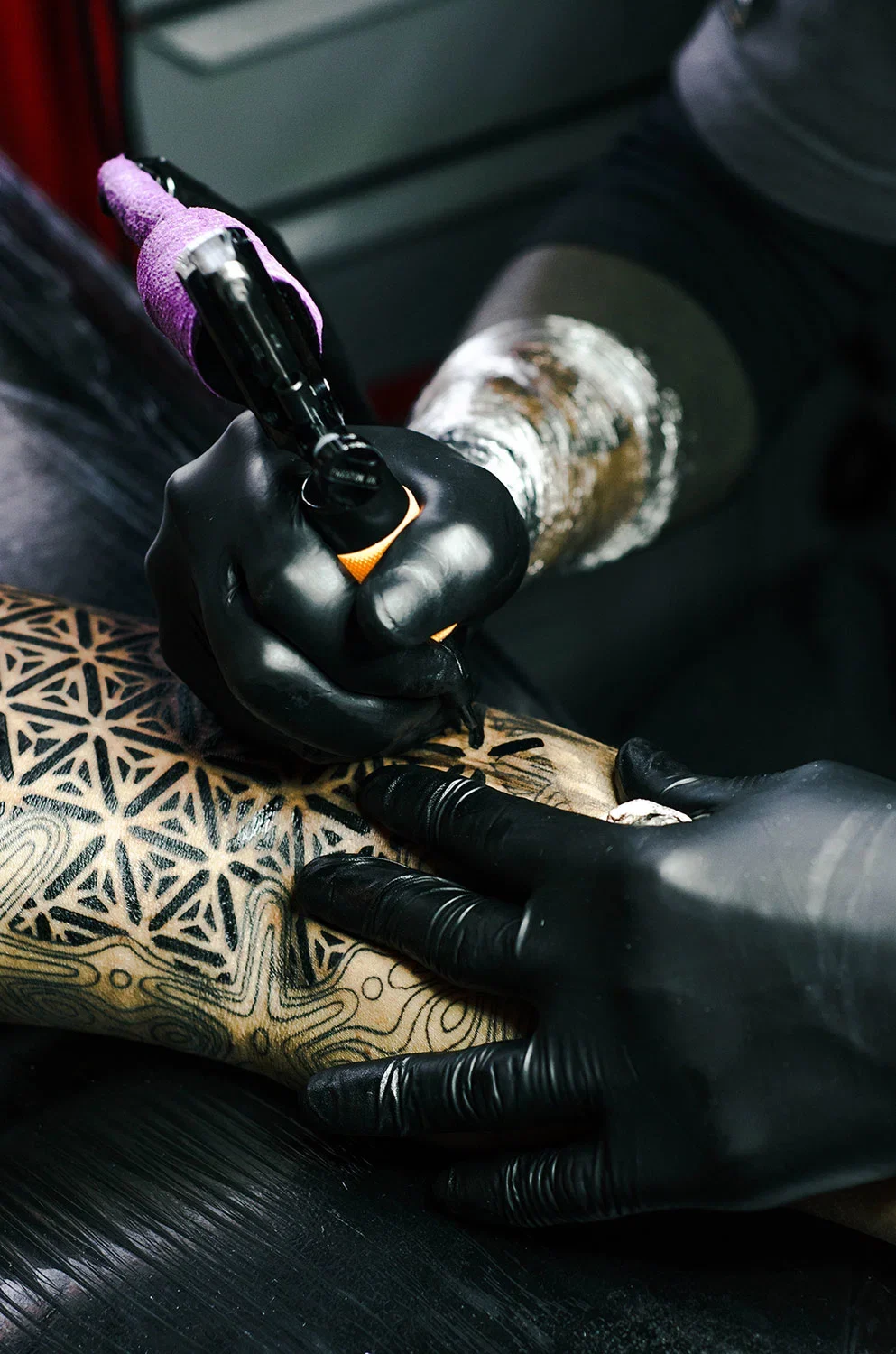 Tattoo artist at work in a studio