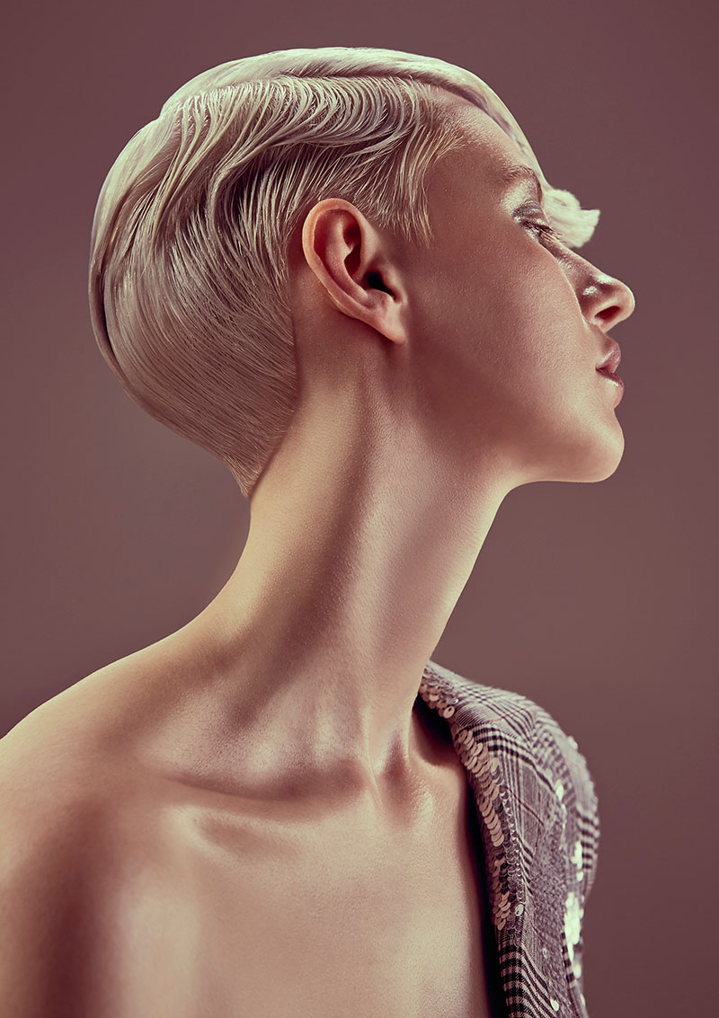 Sculpted short blonde hairstyle shown in profile